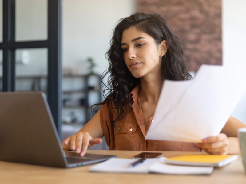Young woman looking at her laptop