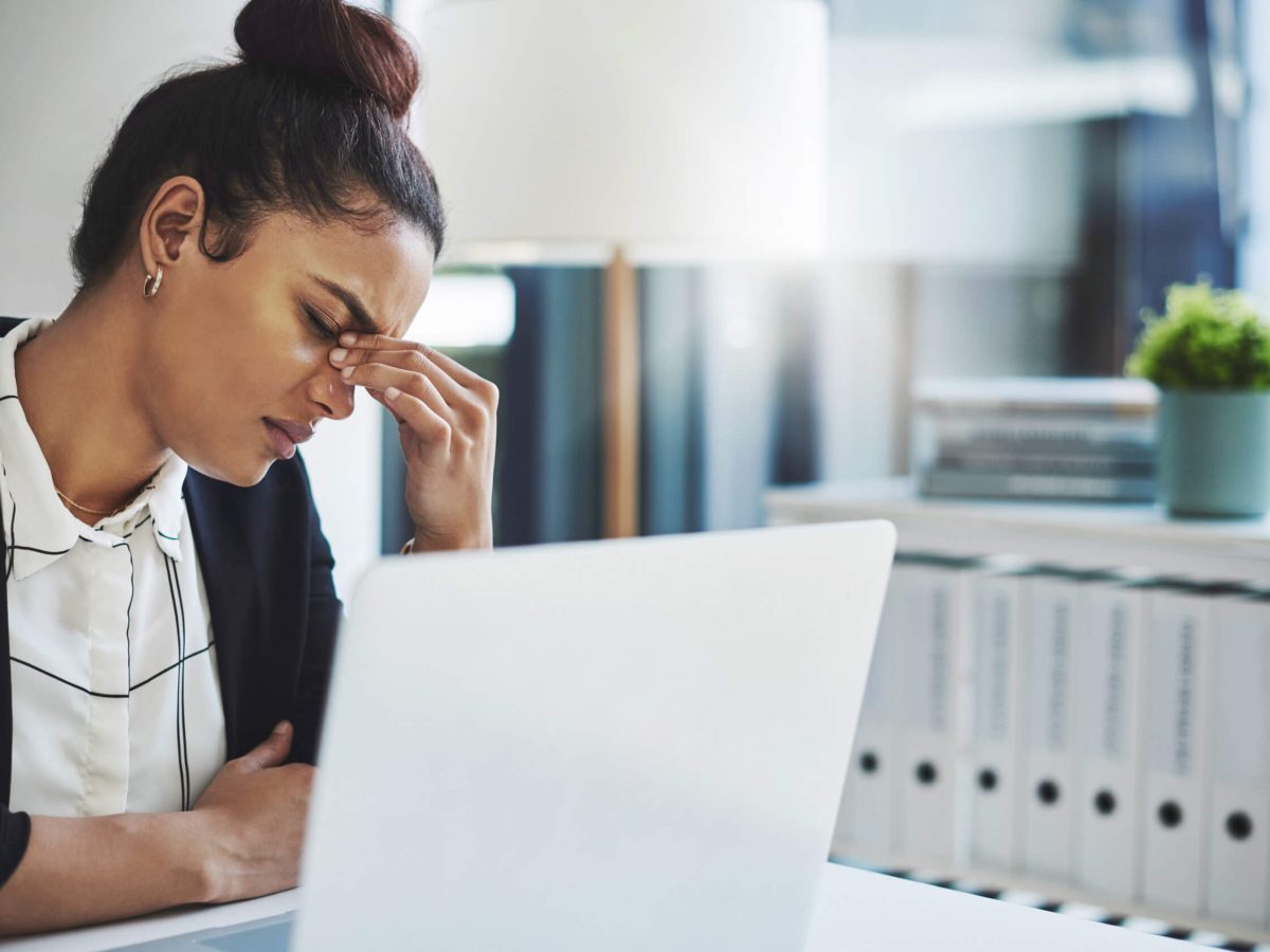 A young businesswoman looking stressed while working at her desk
